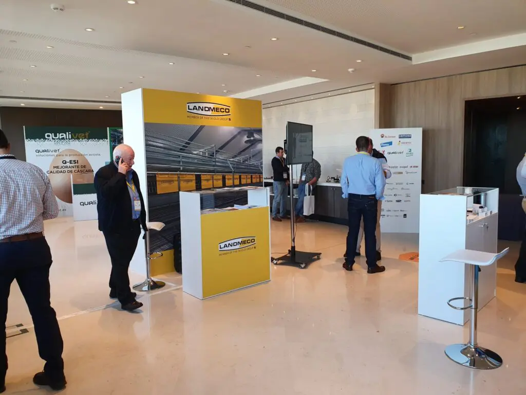 LANDMECO exhibition booth showcasing poultry equipment and aviary systems at an industry trade show.