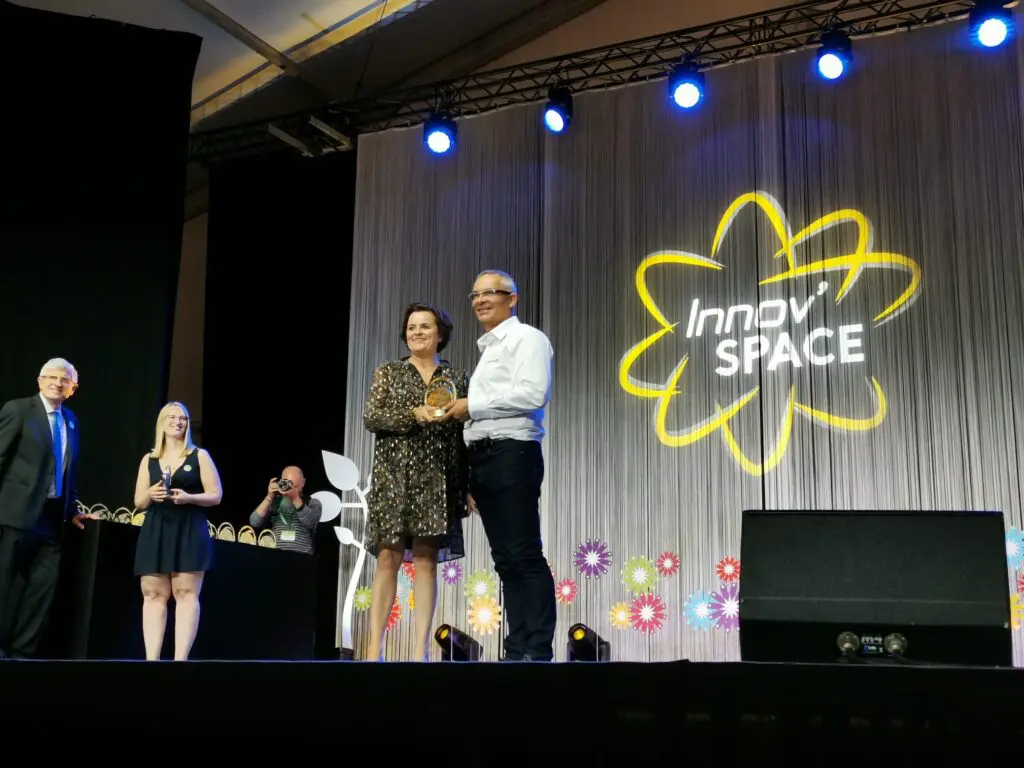 LANDMECO representatives receiving the Innov’SPACE award for innovative poultry equipment on stage.