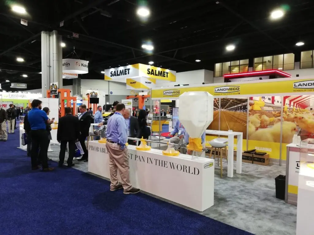 LANDMECO trade show booth featuring automated broiler feeding systems and poultry equipment for professional producers.