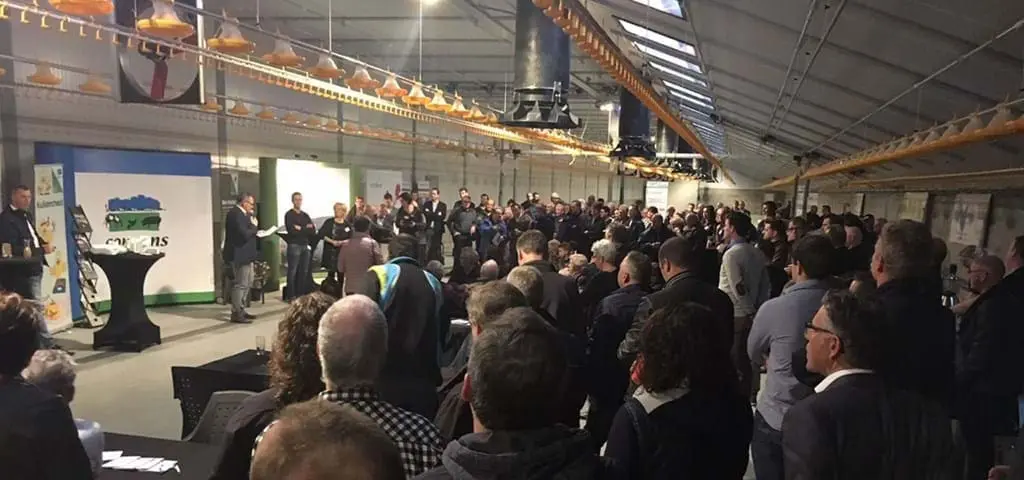 Large crowd of producers attending a Landmeco open house for broiler equipment and automated systems in Holland.