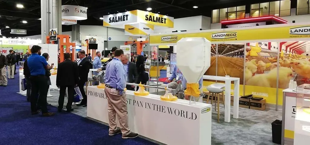 LANDMECO trade show booth at IPPE showcasing broiler pan feeding systems and automated poultry equipment.