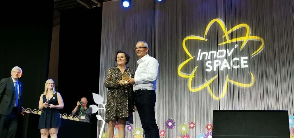 LANDMECO representatives receiving an award for innovative poultry equipment on stage at the Innov'Space event.