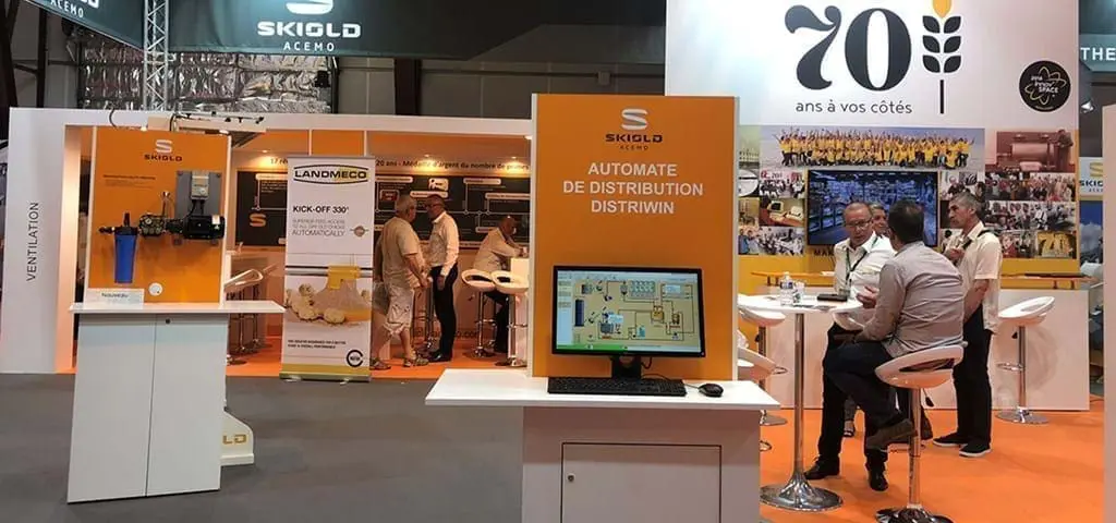 LANDMECO and SKIOLD exhibition booth featuring automated poultry feeding systems and distribution control software.