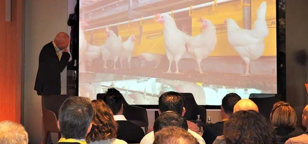 LANDMECO Spain Convention presentation showcasing automated poultry systems for layers and breeders to an audience.