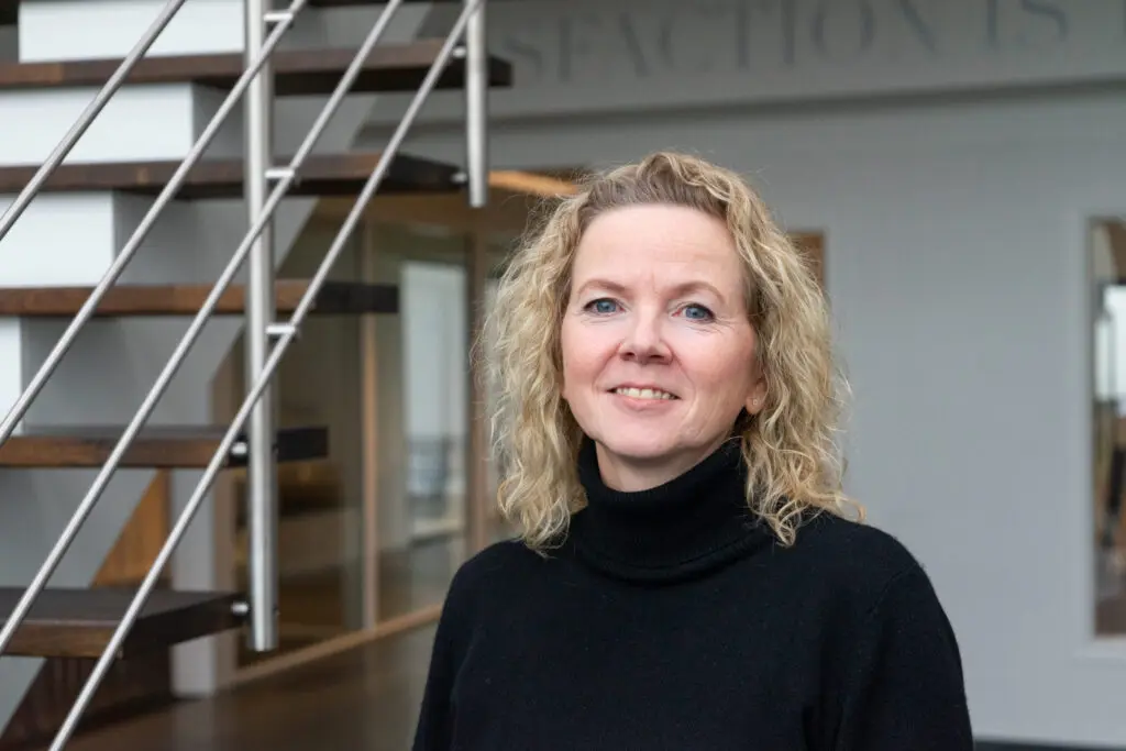 Birgit, Quotation Specialist at LANDMECO poultry equipment manufacturer, in a professional office setting.