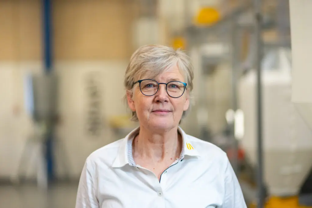 Portrait of Susanne Friis, Regional Sales Director at LANDMECO, in a professional industrial environment.