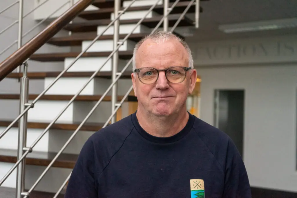 Hans Otto Jensen, Technical Team Lead at LANDMECO poultry equipment manufacturer, in a professional office setting.