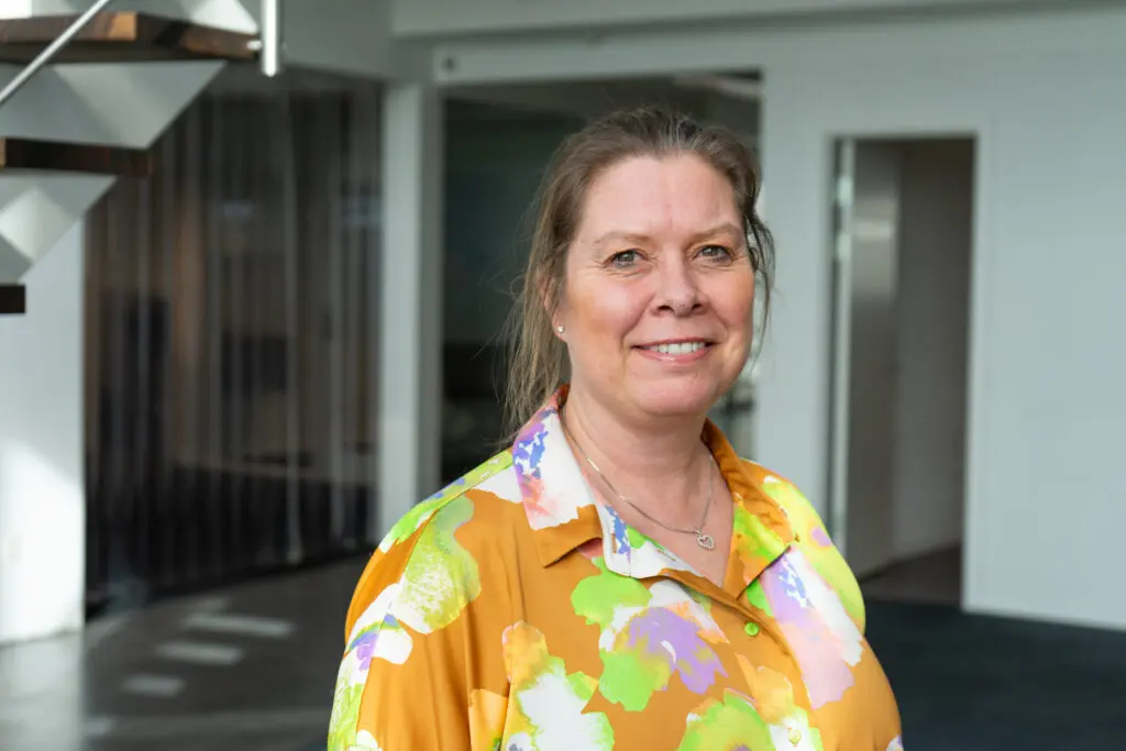 Portrait of Karina Engkjær, Logistics Assistant at LANDMECO, in a professional office setting.