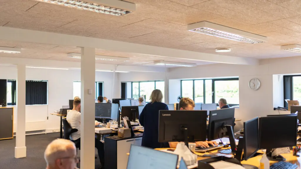 Employees working in the modern LANDMECO office in Ølgod, Denmark, focused on poultry equipment engineering and ESG.