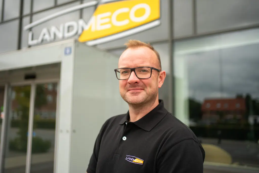Morten Jakobsen wearing a LANDMECO polo shirt in front of the company headquarters in Ølgod, Denmark.