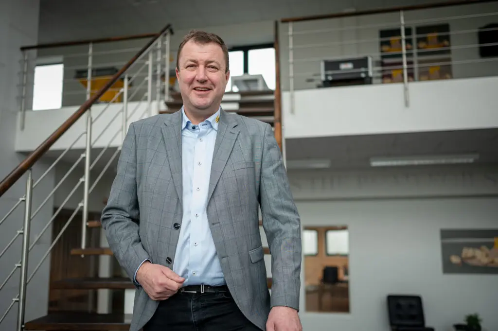 CEO Anders Kristian Andersen of LANDMECO, Denmark, smiling in a professional office environment.