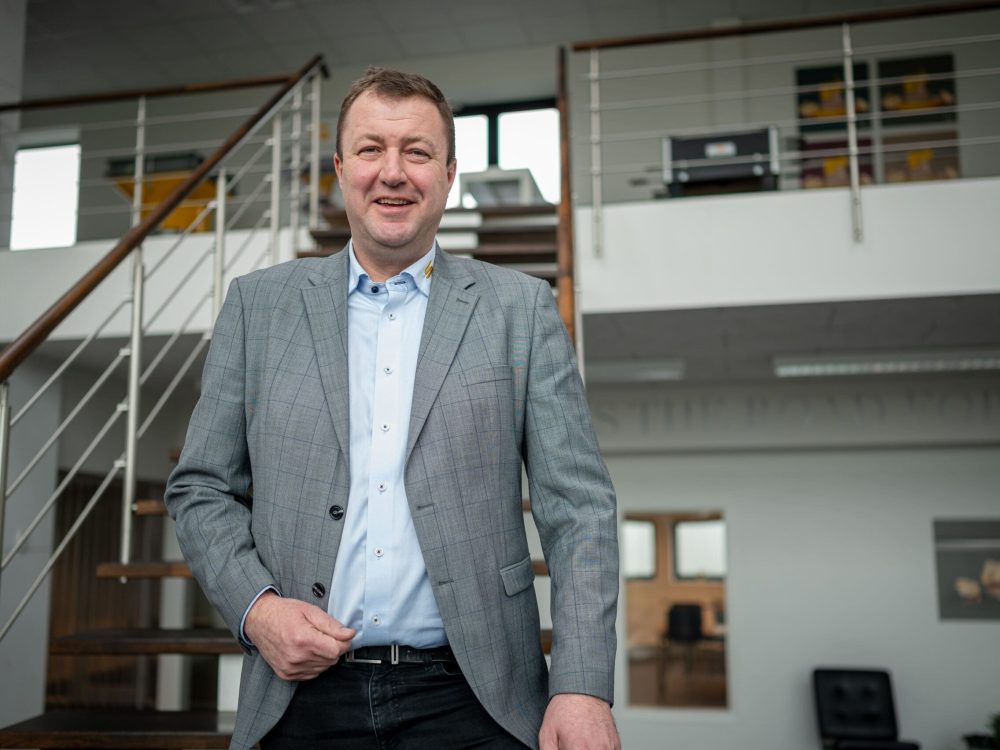 CEO Anders Kristian Andersen of LANDMECO, Denmark, smiling in a professional office environment.