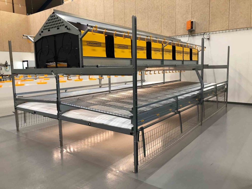 LANDMECO Combo One Tier aviary system with integrated nests, feeding lines, and manure belts for layer housing.