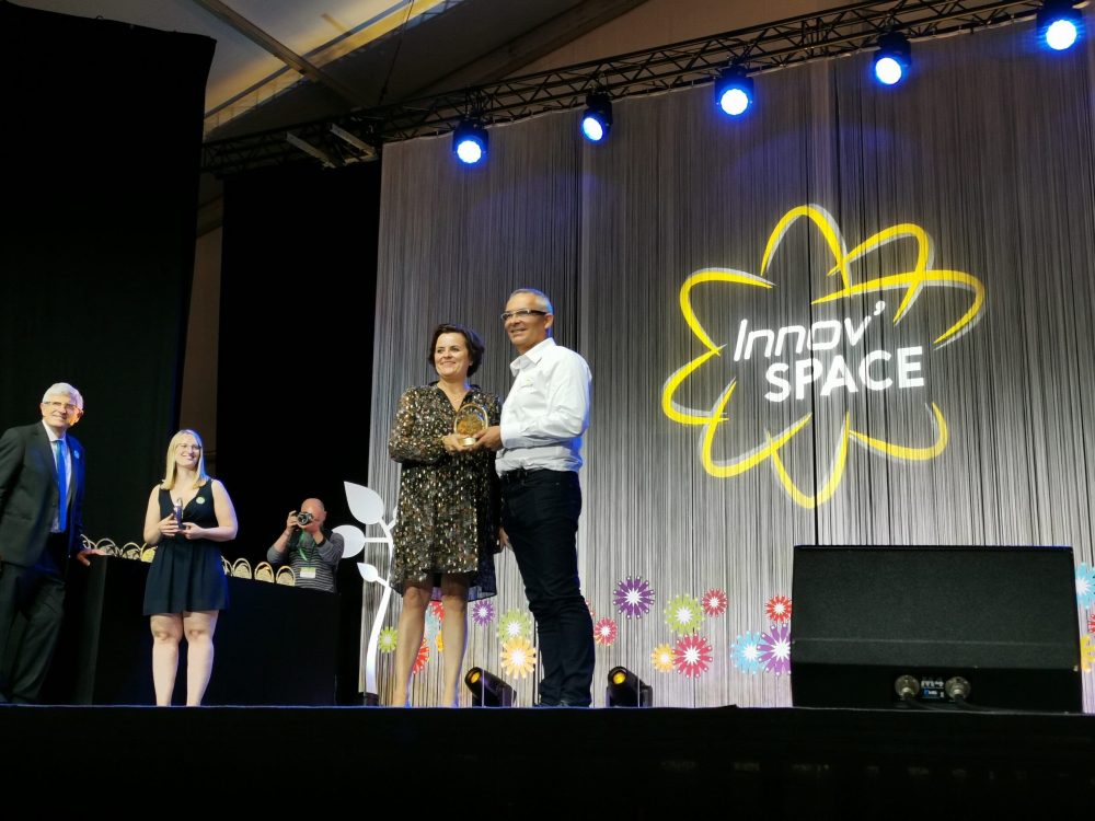LANDMECO representatives receiving the Innov’SPACE award for innovative poultry equipment on stage.