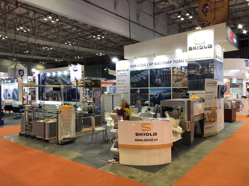 LANDMECO and SKIOLD trade show booth featuring poultry feeding systems and industrial poultry equipment in Vietnam.