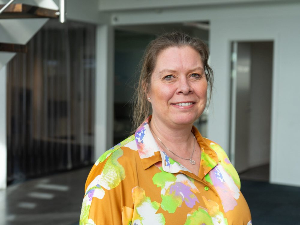 Portrait of Karina Engkjær, Logistics Assistant at LANDMECO, in a professional office setting.