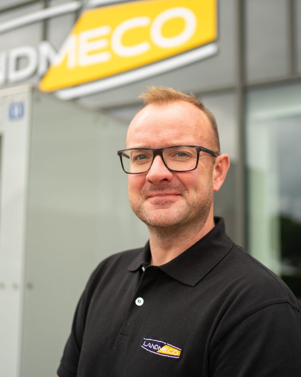 Morten Jakobsen wearing a LANDMECO polo shirt in front of the company headquarters in Ølgod, Denmark.