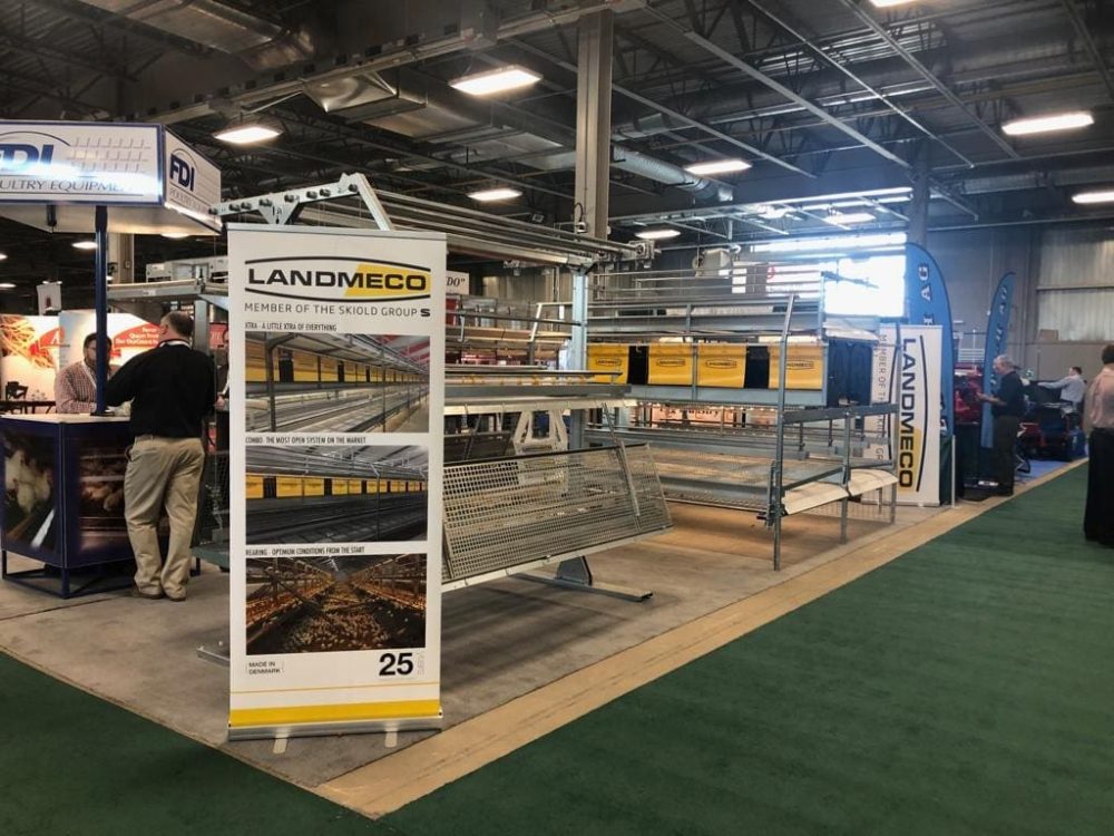 LANDMECO trade show booth showcasing Combo aviary systems and rearing equipment for professional poultry producers.