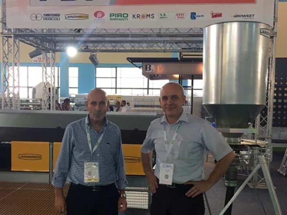LANDMECO specialists showcasing poultry feeding systems and aviary equipment at a professional industry trade fair.