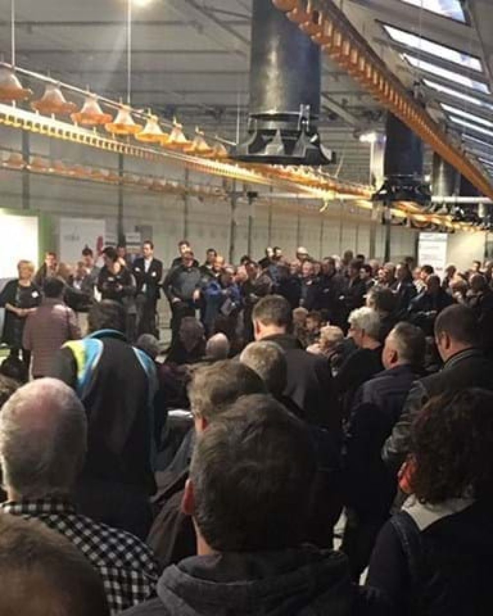 Large crowd of producers attending a Landmeco open house for broiler equipment and automated systems in Holland.