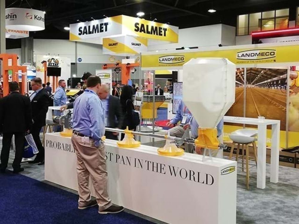 LANDMECO trade show booth at IPPE showcasing broiler pan feeding systems and automated poultry equipment.