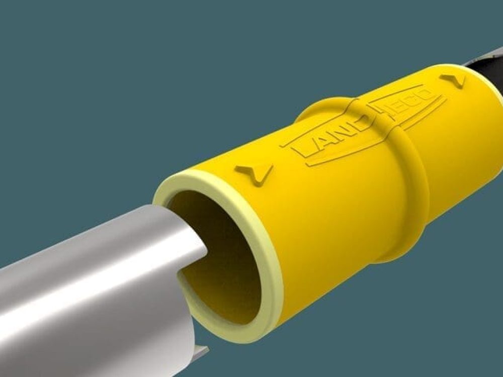 Close-up of a yellow Landmeco Safe Connector joining two metal pipes in a professional poultry production system.