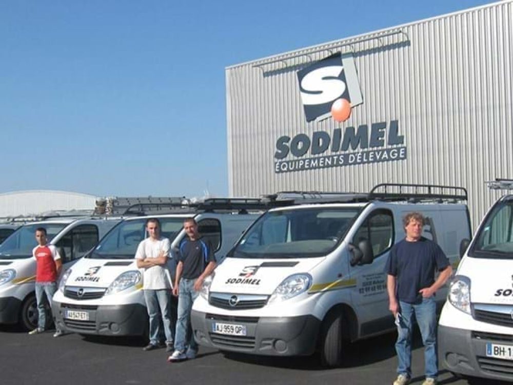 Sodimel service team with branded vans in front of their poultry equipment warehouse, a LANDMECO partner.