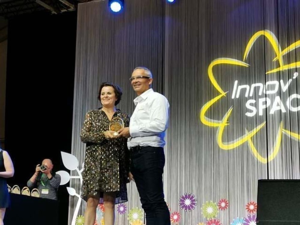 LANDMECO representatives receiving an award for innovative poultry equipment on stage at the Innov'Space event.