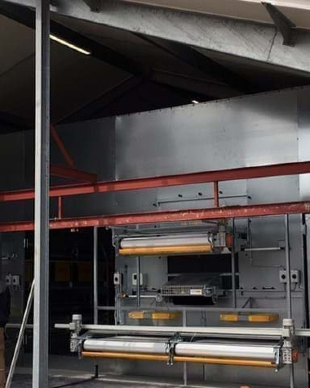 Technicians installing LANDMECO poultry aviary tiers in a new commercial house for efficient egg production.