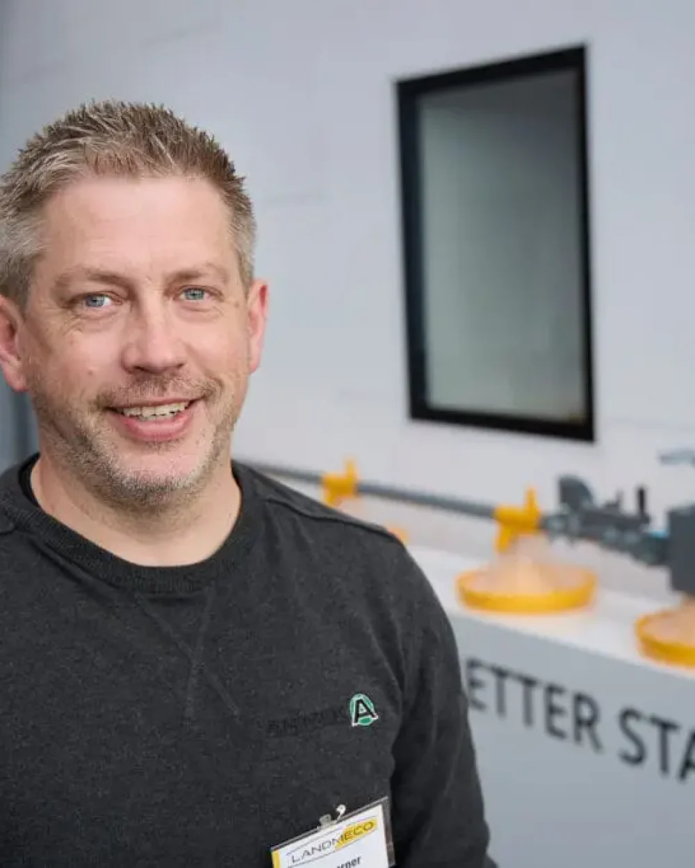 Ola Larner, co-owner of Swedish LANDMECO dealer Animek System AB, standing in front of poultry feeding equipment.